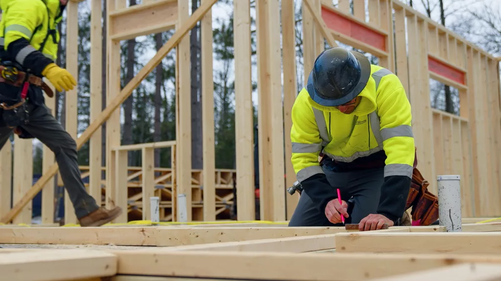 construction workers marking studs and working on a new construction home